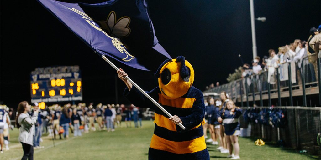 Kingfisher Public Schools mascot waving a flag