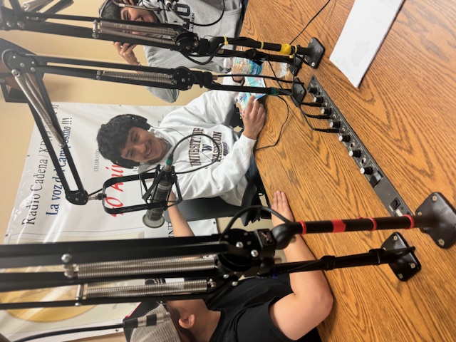  smiling high school students ready to broadcast in a radio station