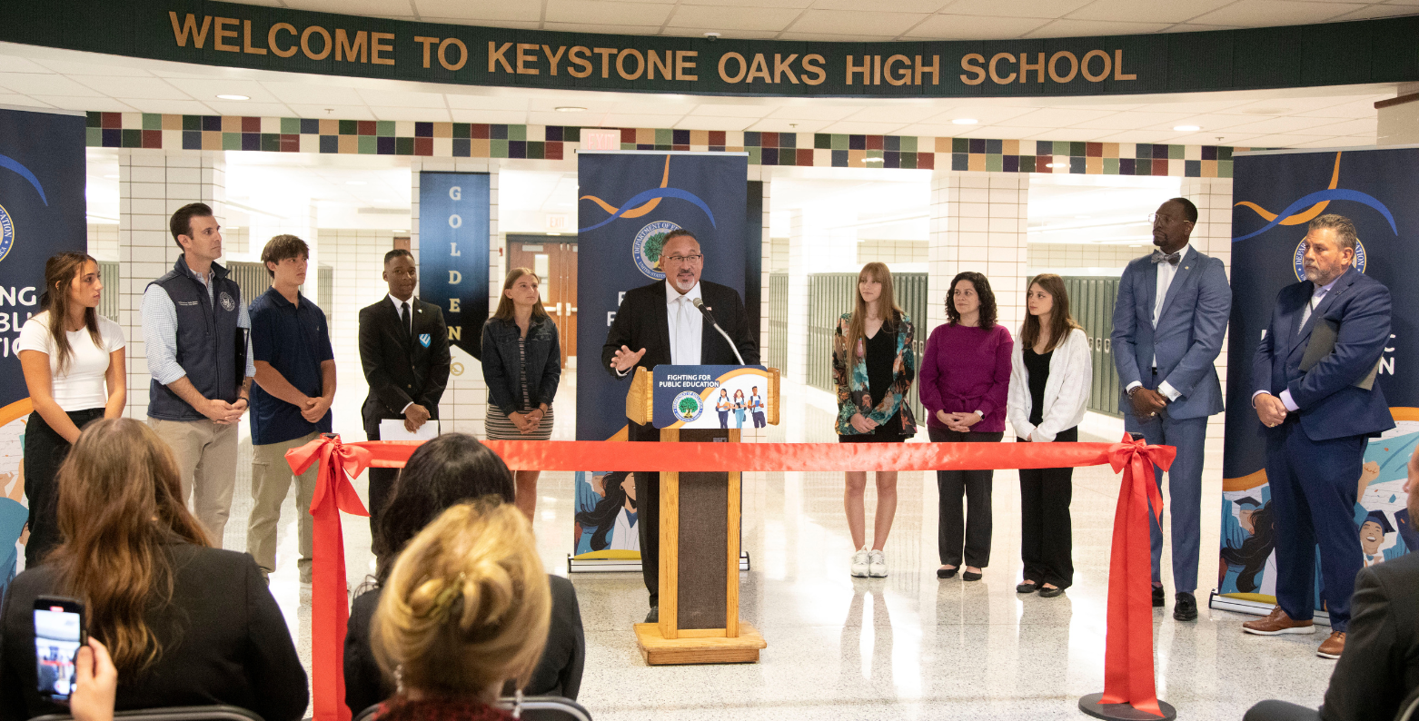 Eleven people at a press conference at Keystone Oaks High School