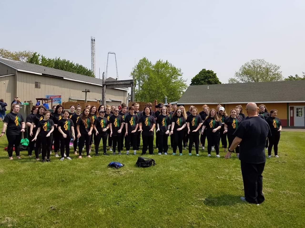 chorus members rehearsing in the sunshine