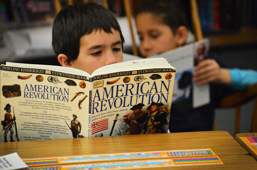 Fourth-grader Isiah Soto digests some history during independent reading time.