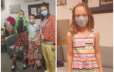 Students with the nurse showing off their rainbow colors
