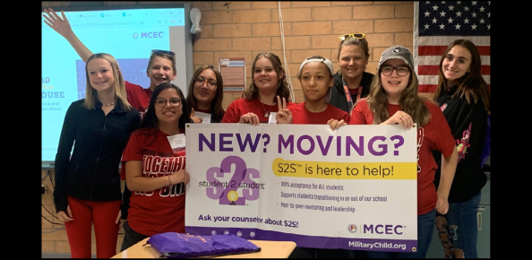 group picture of Student2Student kids - Front (from left): Reagan Gebhart (Black long sleeve & red pants), Jessica Chavez, Emery Long, Joi Blackmon, Indy Fiore Back (from left): Isaac Miller (in back with arm up), Nicolette Martinez, April Petty, Kayleigh Charest