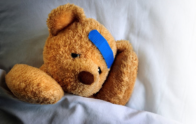 Photo of a teddy bear with a bandage from an injury.