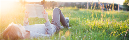 girl reading in the grass 