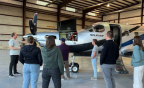  Students gather around an airplane