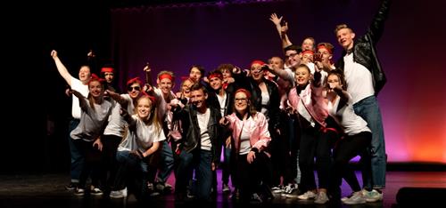 Choir members perform on stage