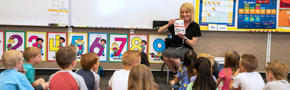 teacher with flash cards and class