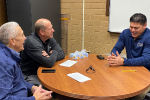  Tim Smith, Gary Thomas, and John Sanchez talk around a table