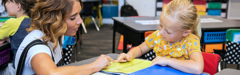 Teacher helping student