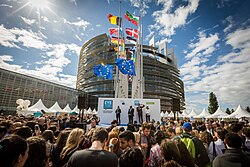 European Parliament opening in Strasbourg with crowd and many countries' flags on flagpoles