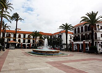 View of a square in Lepe, with a fountain in the middle