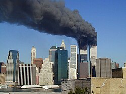 The World Trade Center towers after each being hit with hijacked Boeing 767s