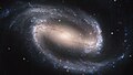 Image 25NGC 1300 is a barred spiral galaxy located roughly 69 million light-years away in the direction of the constellation Eridanus. In its core, the nucleus shows its own extraordinary and distinct "grand-design" spiral structure that is about 3,300 light-years long.