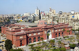 Two-story neoclassical building with arched windows and ornate facade in Cairo