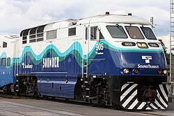 A large locomotive in the Sounder livery with "905" painted on the side