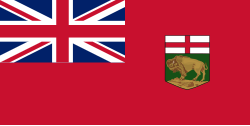 A red flag with a large Union Jack in the upper left corner and a shield, consisting of St. George's Cross over a left-facing bison standing on a rock, on the right side