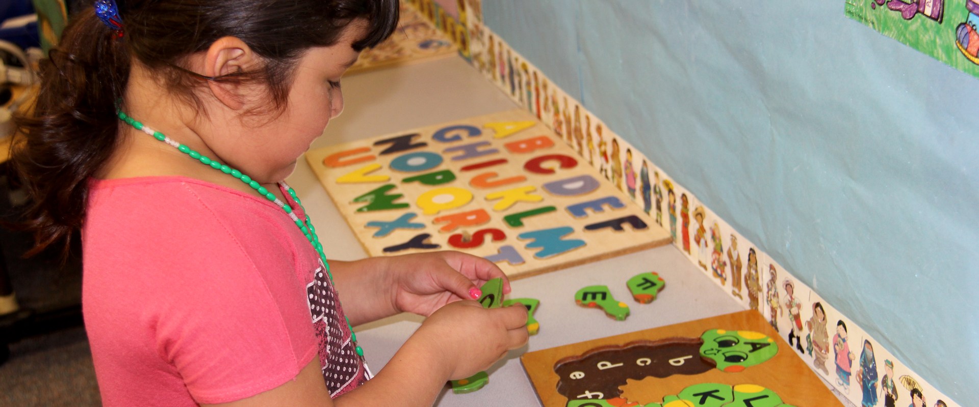 little girl doing a puzzle