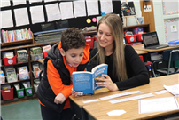 Mrs. Gundrum assisted a student with a reading activity thumbnail265570