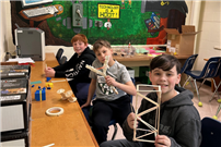 Three students show off their creations. thumbnail265820