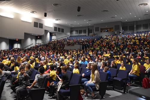 Photo of audience fanned out in auditorium 