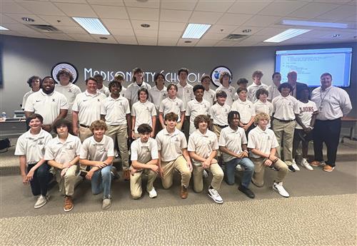 team photo in front of the board room
