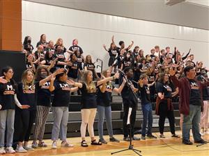 choir members singing from bleachers