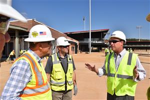 Superintendent Parker with Team Owner Ralph Nelson and a Turner Universal official inside unfinished stadium 