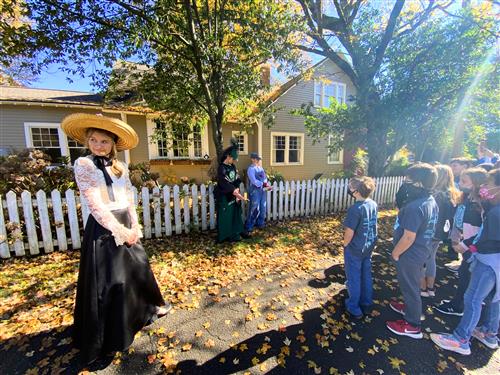 students outside historic house getting a briefing on its history