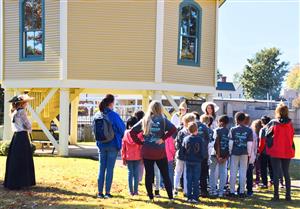 Students on walking tour by Roundhouse Railroad Depot in downtown Madison