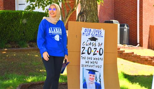 Student in front of Bob Jones Senior Class of 2020 Sign in Her front Yard 