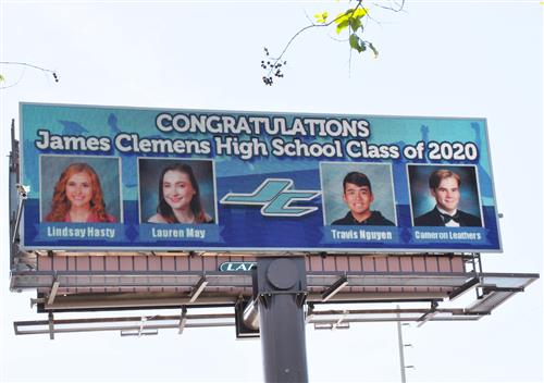 Billboard showing four seniors pictures from James Clemens High School that will rotate through all 470 seniors 