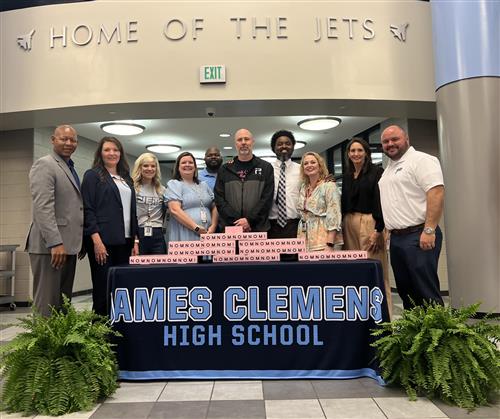  JetsPress teacher Clay Combs standing with school leadership in James Clemens lobby