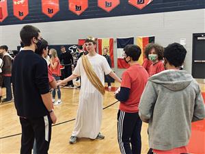 Student in drama costume answering questions from prospective freshmen theater students