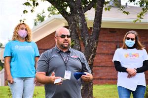 Assistant Bob Jones Band Director Kevin Smart accepting check 