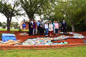 Group photo of River of Hope reps by colored rocks 