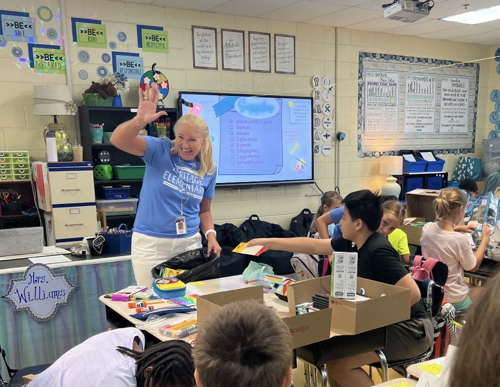  Teacher waving to students in her class