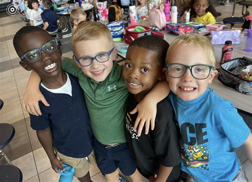 four young boy classmates smiling r
