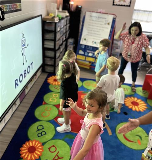 teacher leading class in lesson on screen