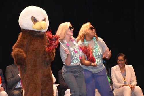 Horizon Eagle mascot in costume dancing with principal and assistant principal