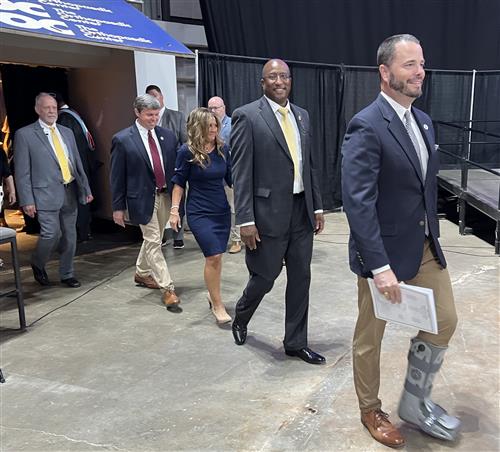 All five board of education members leading the lineup to stage where diplomas will be given out