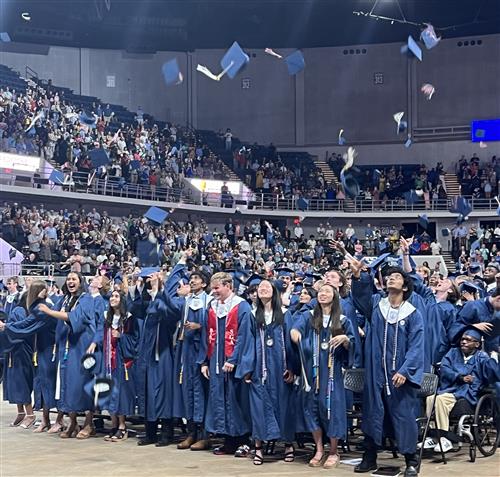 graduates tossing caps in the air