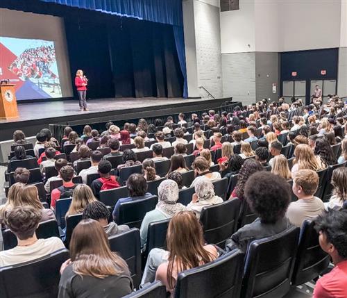 Bob Jones Principal Sylvia Lambert addressing auditorium of juniors