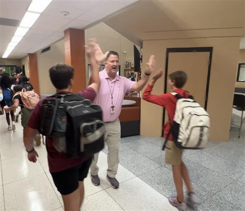 Prncipal Shannon Brown high-fiving students at Liberty Middle School