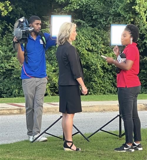 Elementary principal being interviewed by a TV station