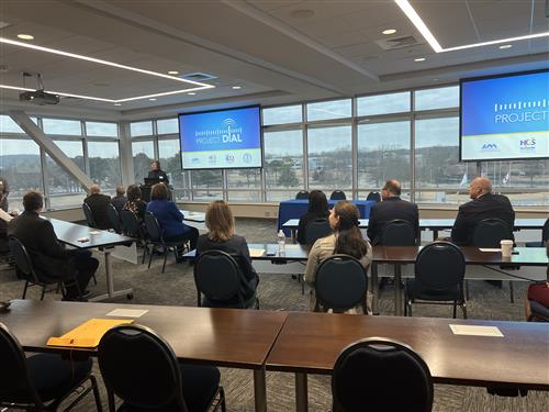 wide angle view of room with Project DIAL on screen