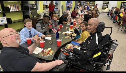 veterans sitting with students at lunch