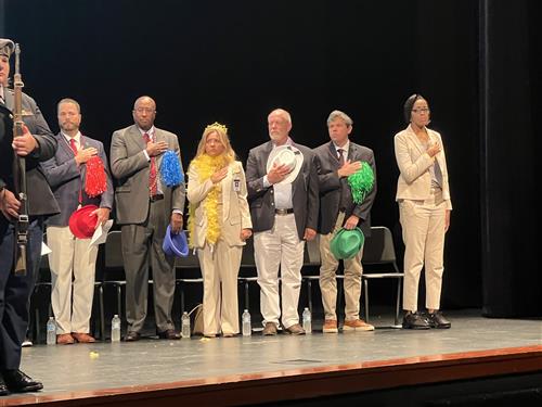 Officials standing at attention during pledge
