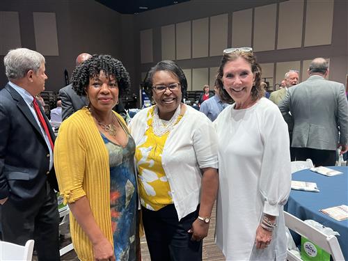 Early school founders Shelia Nash-Stevenson and Debbie Overcash with charter MCS employee LaTisha King in center
