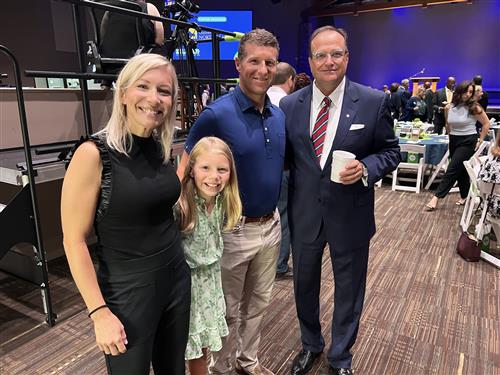 Caroline Turner and parents along with superintendent Dr. Nichols posing for a photo